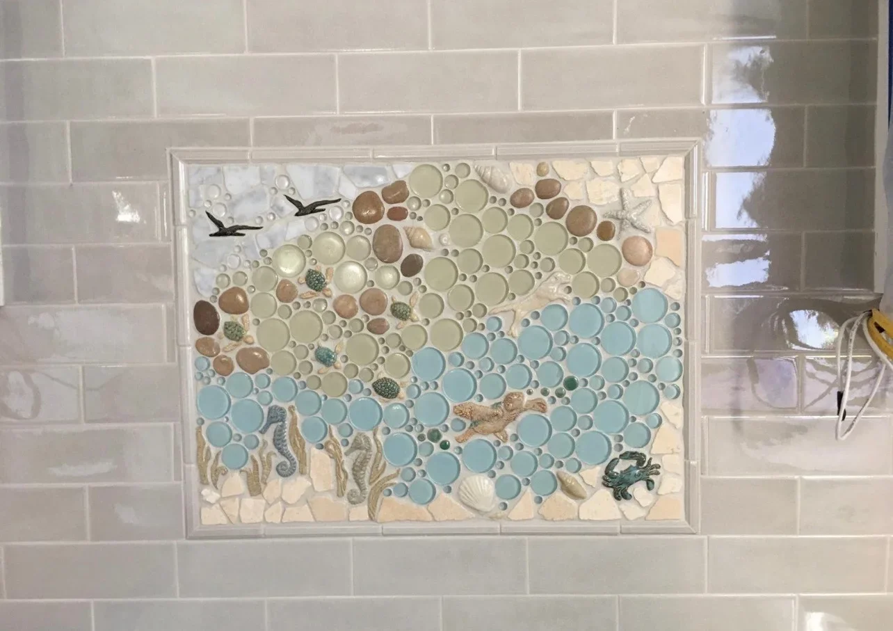 Glass bubble tile backsplash with coastal design, blue and cream circles with sea-life accents