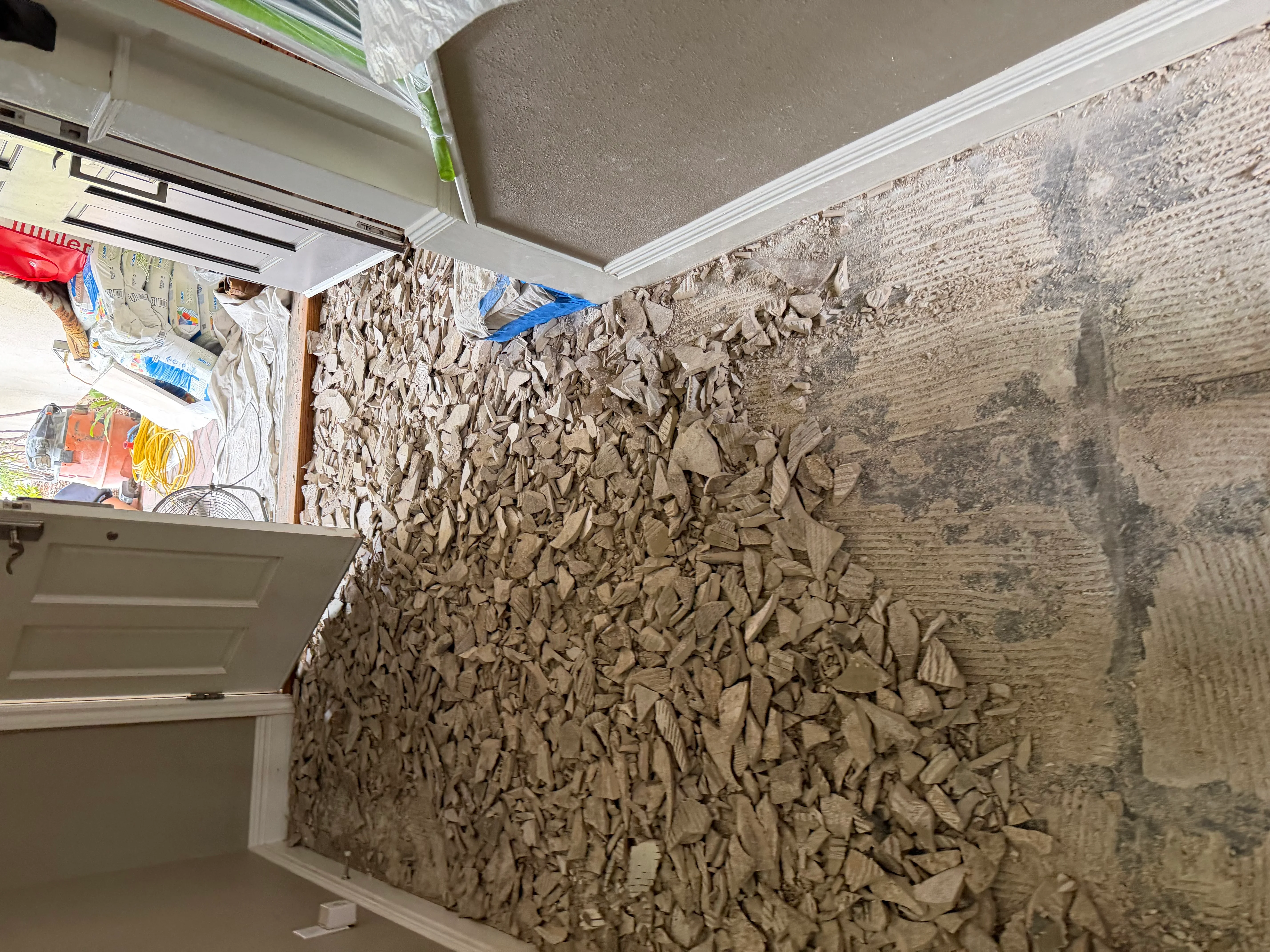 Textured stone wall with dimensional surface pattern and white trim molding